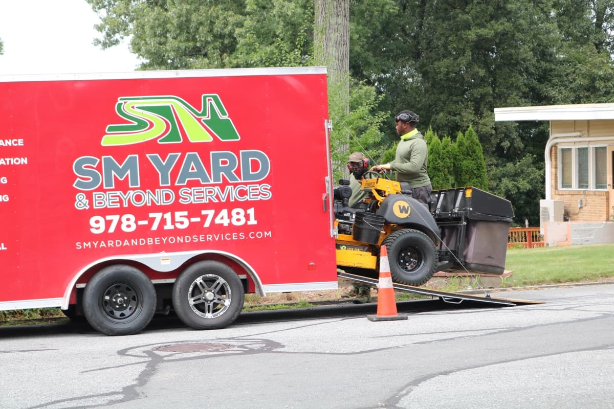 Elijah and Timothy, owners of SM Yard and Beyond, with their equipment trailer