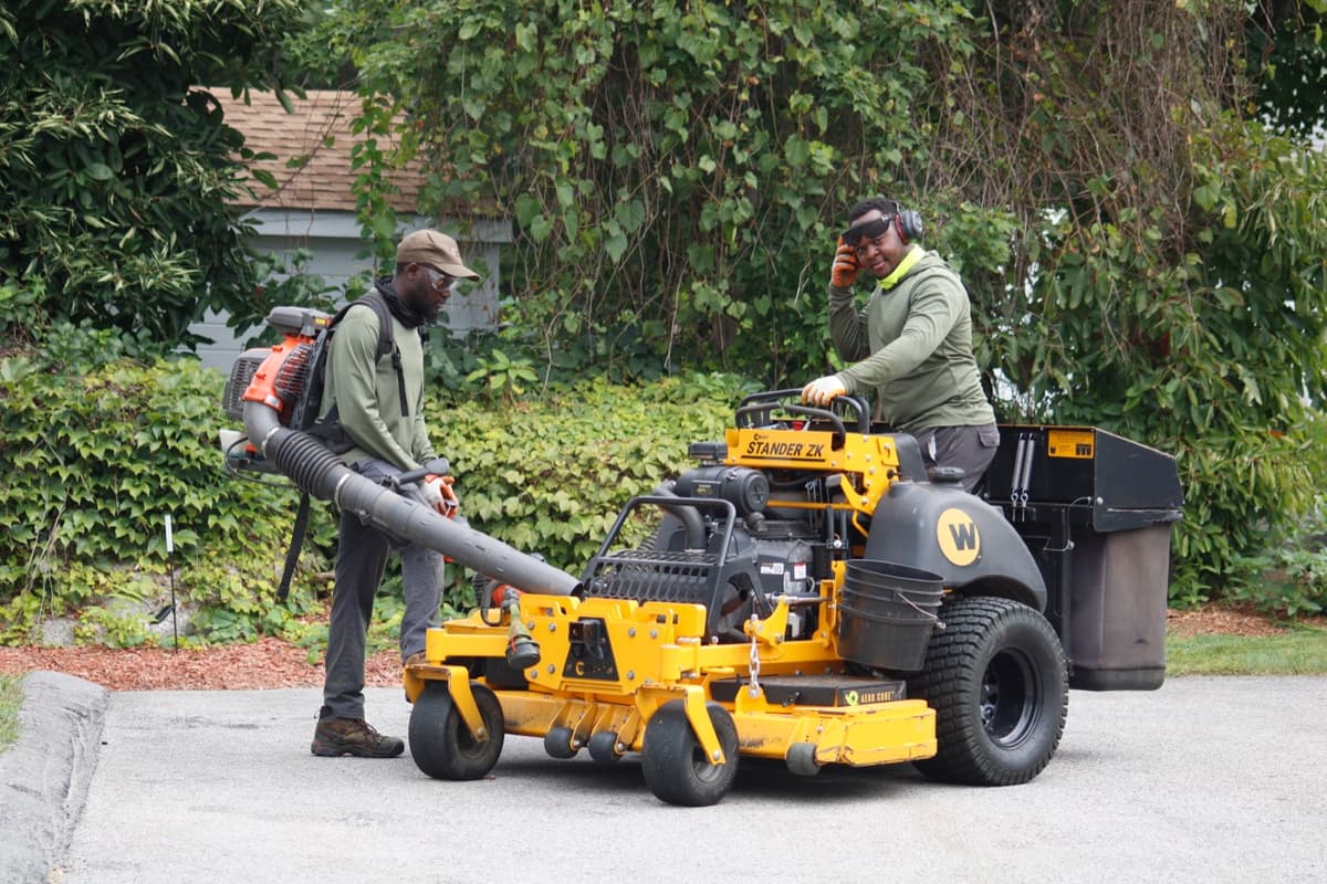 The crew unloading a mower from the trailer