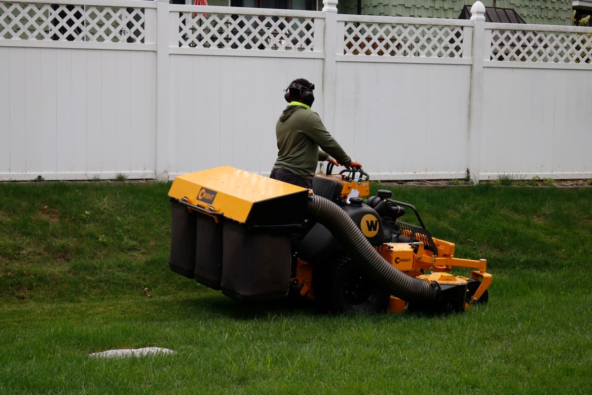 Mowing a well-kept lawn with a stand-on mower